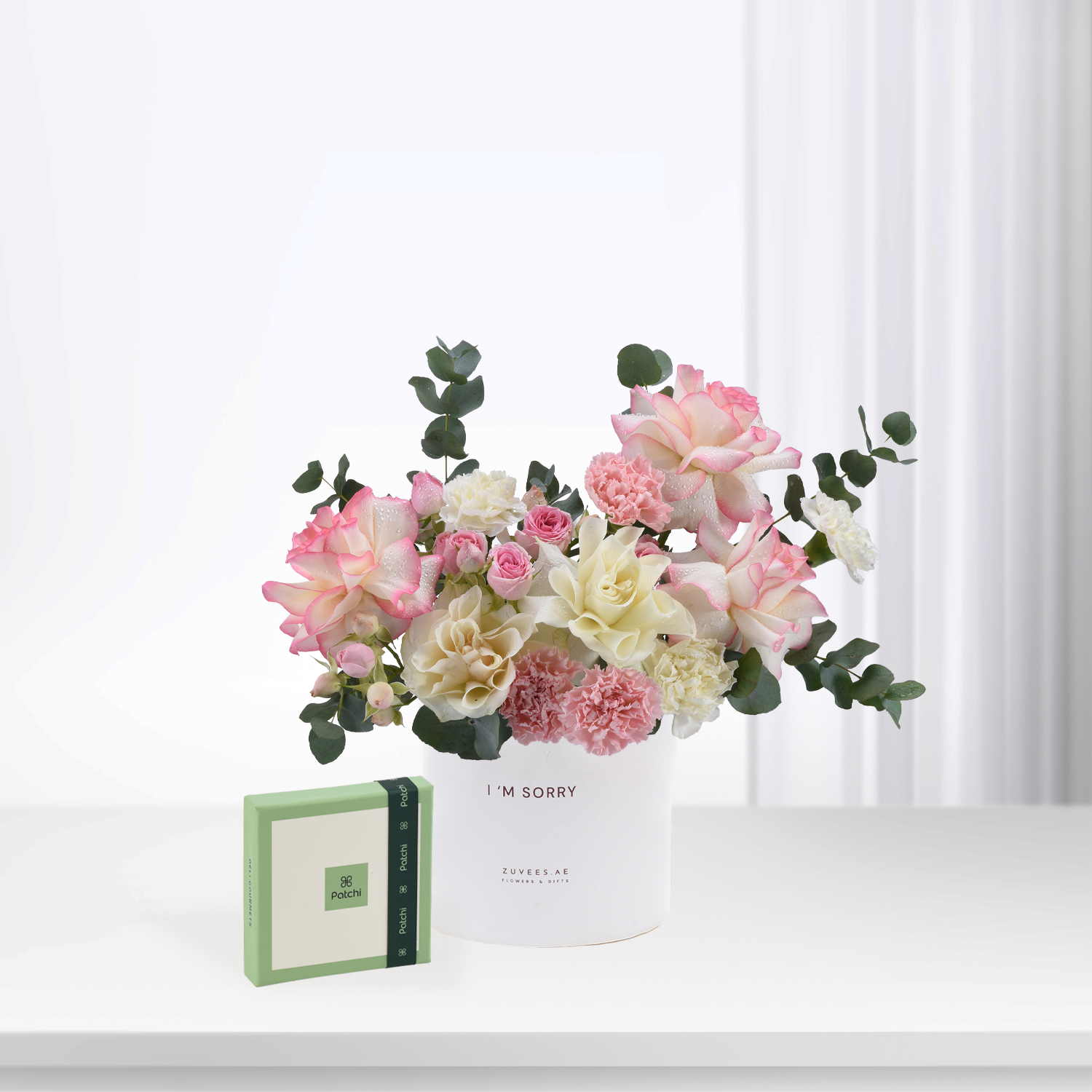 Soft pink, white roses and carnations in white vase with "I&