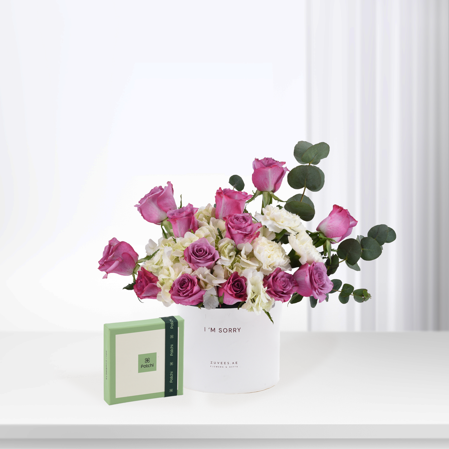 Pink roses and white blooms in white vase with "I&