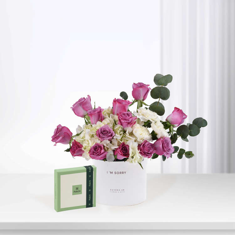 Pink roses and white blooms in white vase with "I&