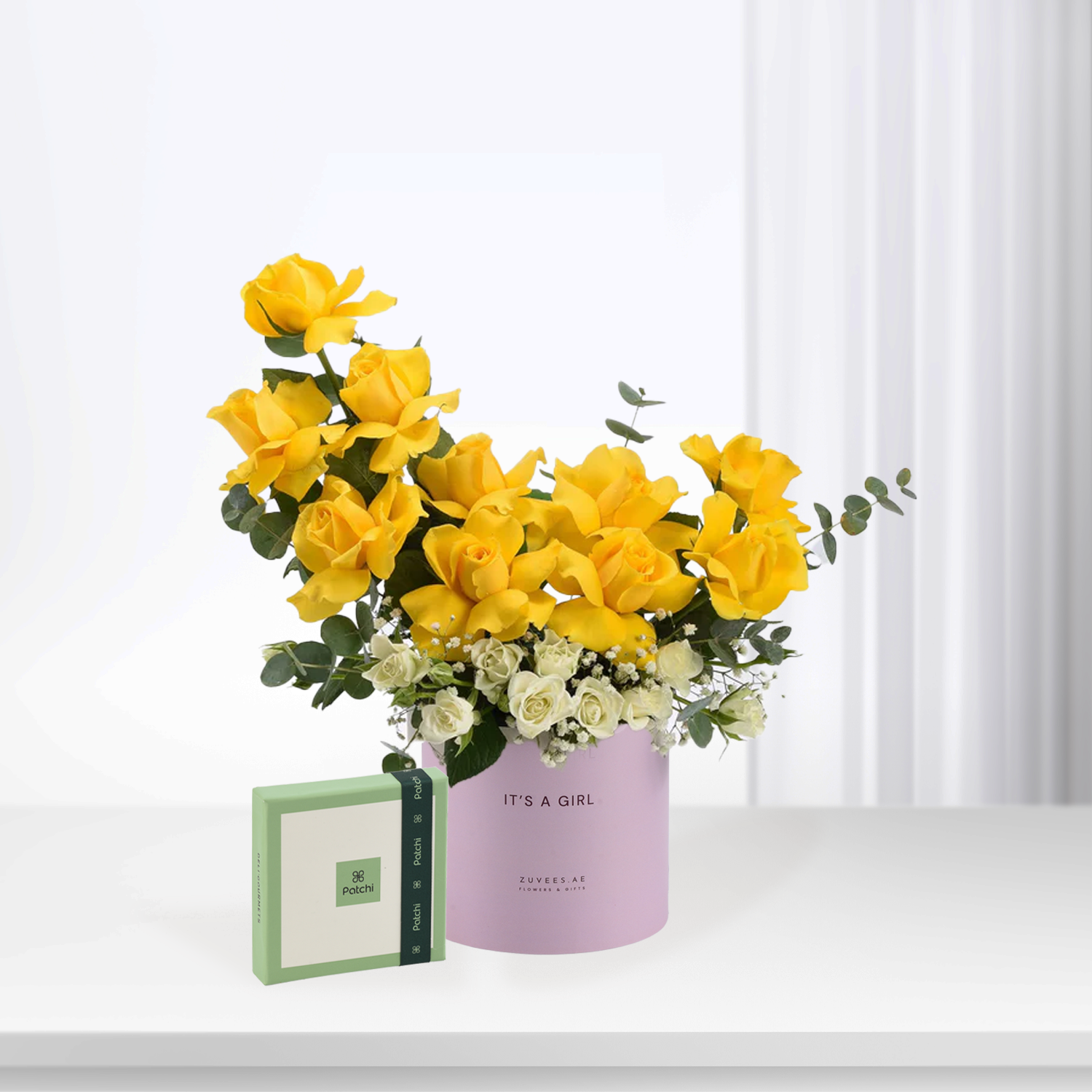 Vibrant yellow roses and white blooms in lilac box, "It&