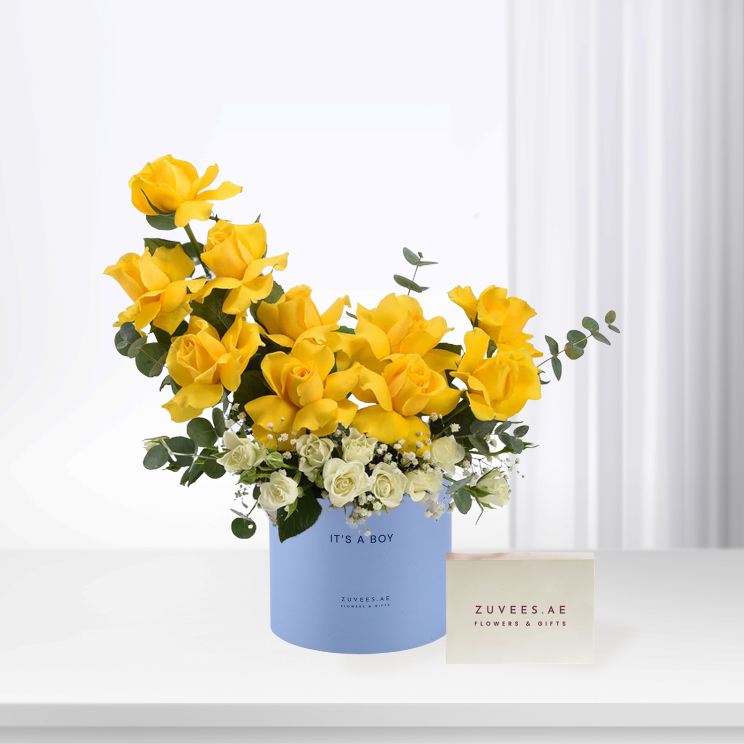 Vibrant yellow roses and white blooms in a blue "It&