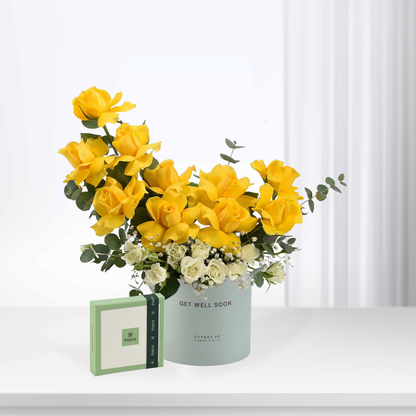 Vibrant yellow roses with white accents in mint container, "Get Well Soon" message.