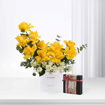 Vibrant yellow roses with white accents in white box reading "I&