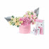 Pink floral arrangement with silver accents and matching skincare set.