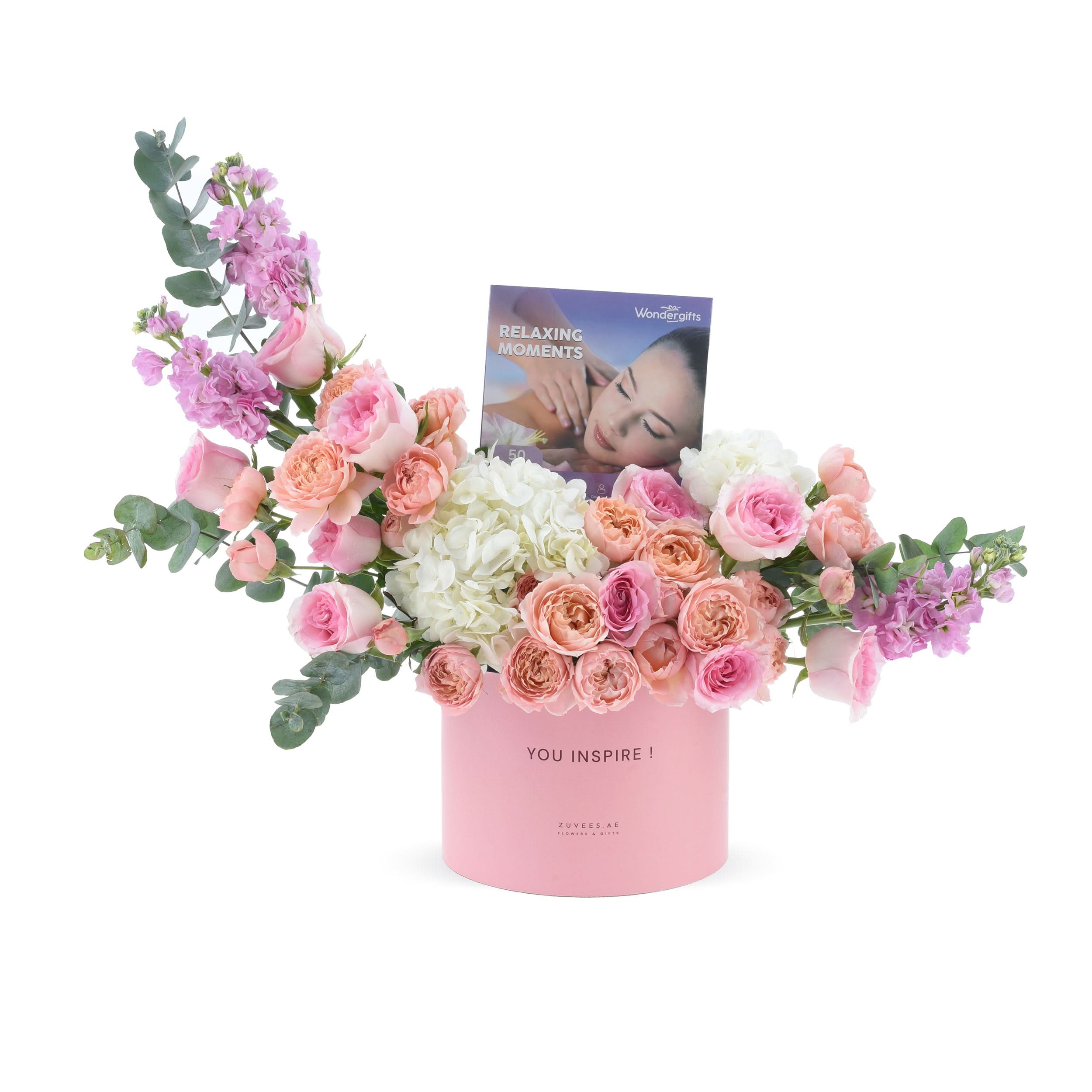 Soft pink roses, hydrangeas, and eucalyptus in a pastel pink box with “YOU INSPIRE!” message.
