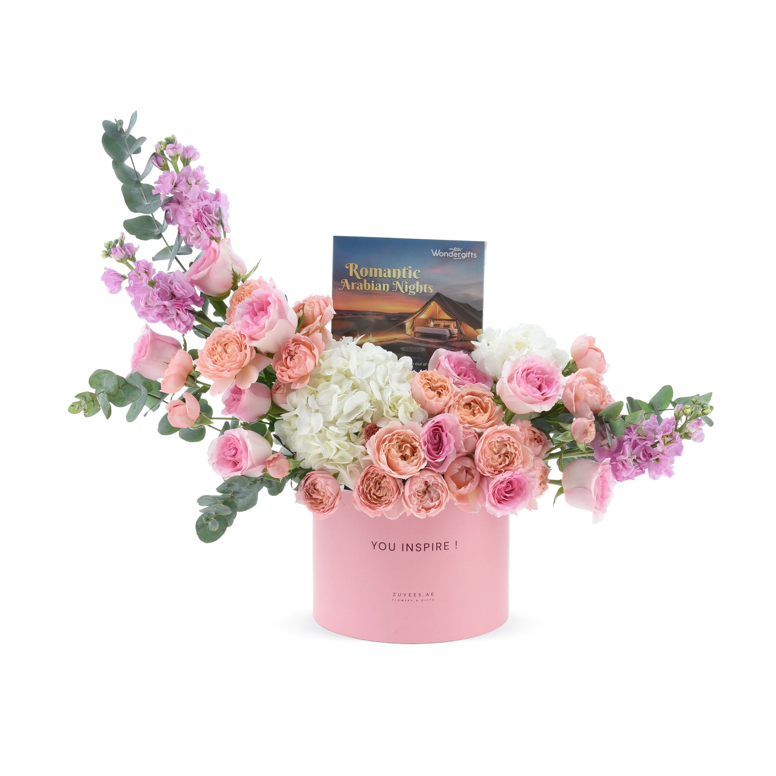Soft pink roses, hydrangeas, and eucalyptus in a blush pink "YOU INSPIRE!" box with "Romantic Arabian Nights" booklet.