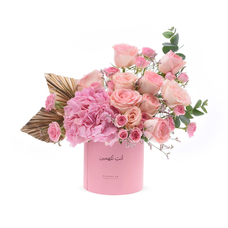 Soft pink roses and hydrangeas in elegant cylindrical box with gold leaf accent.