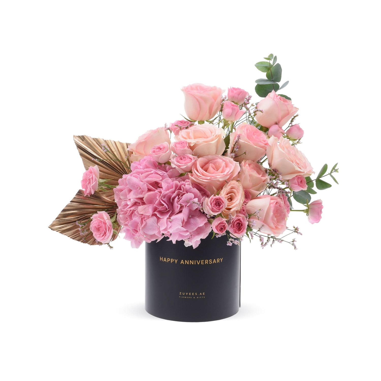 Elegant pink roses and hydrangeas in black box with gold "Happy Anniversary" text.