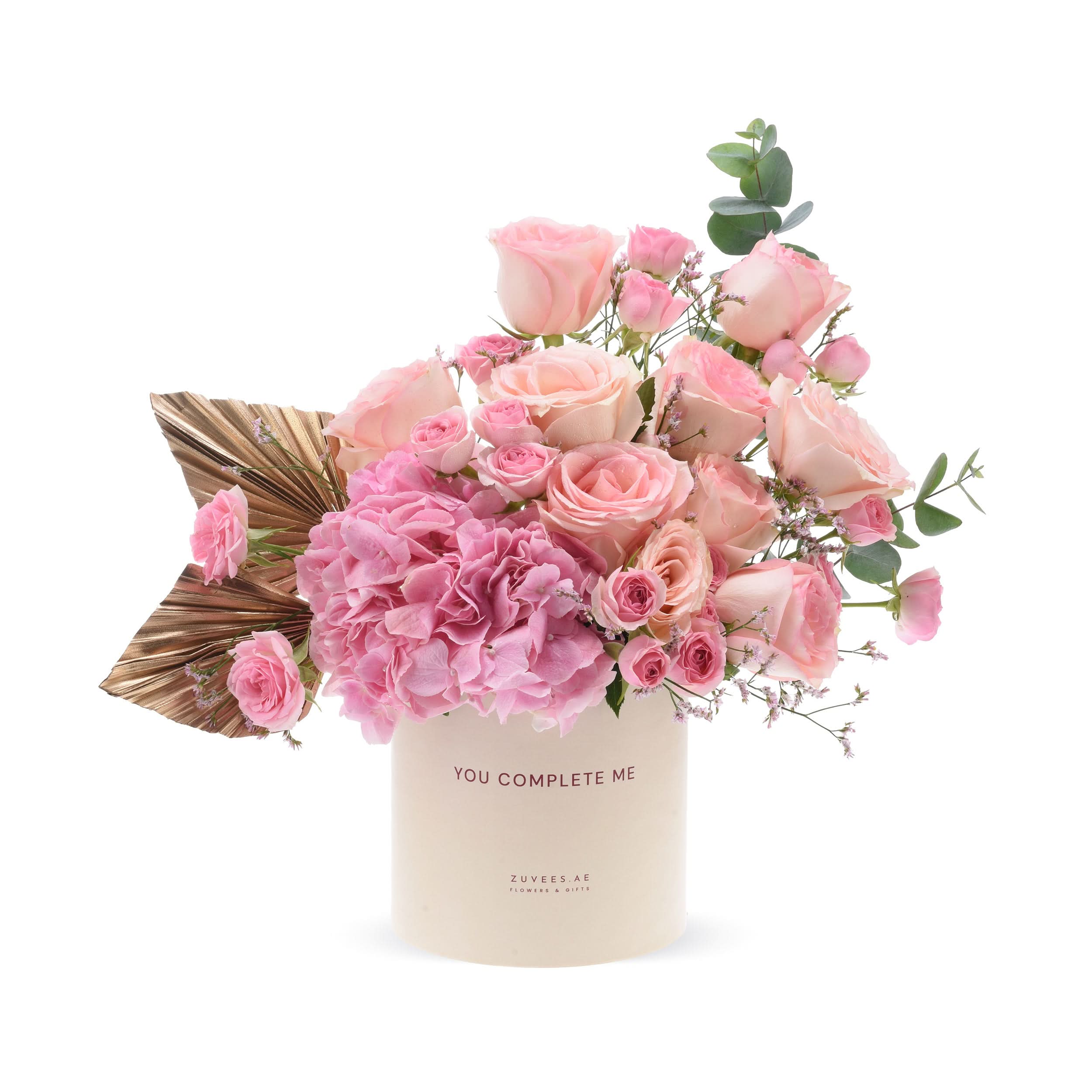 Pink roses, hydrangeas, eucalyptus in cream box with “You Complete Me” text, gold accents.