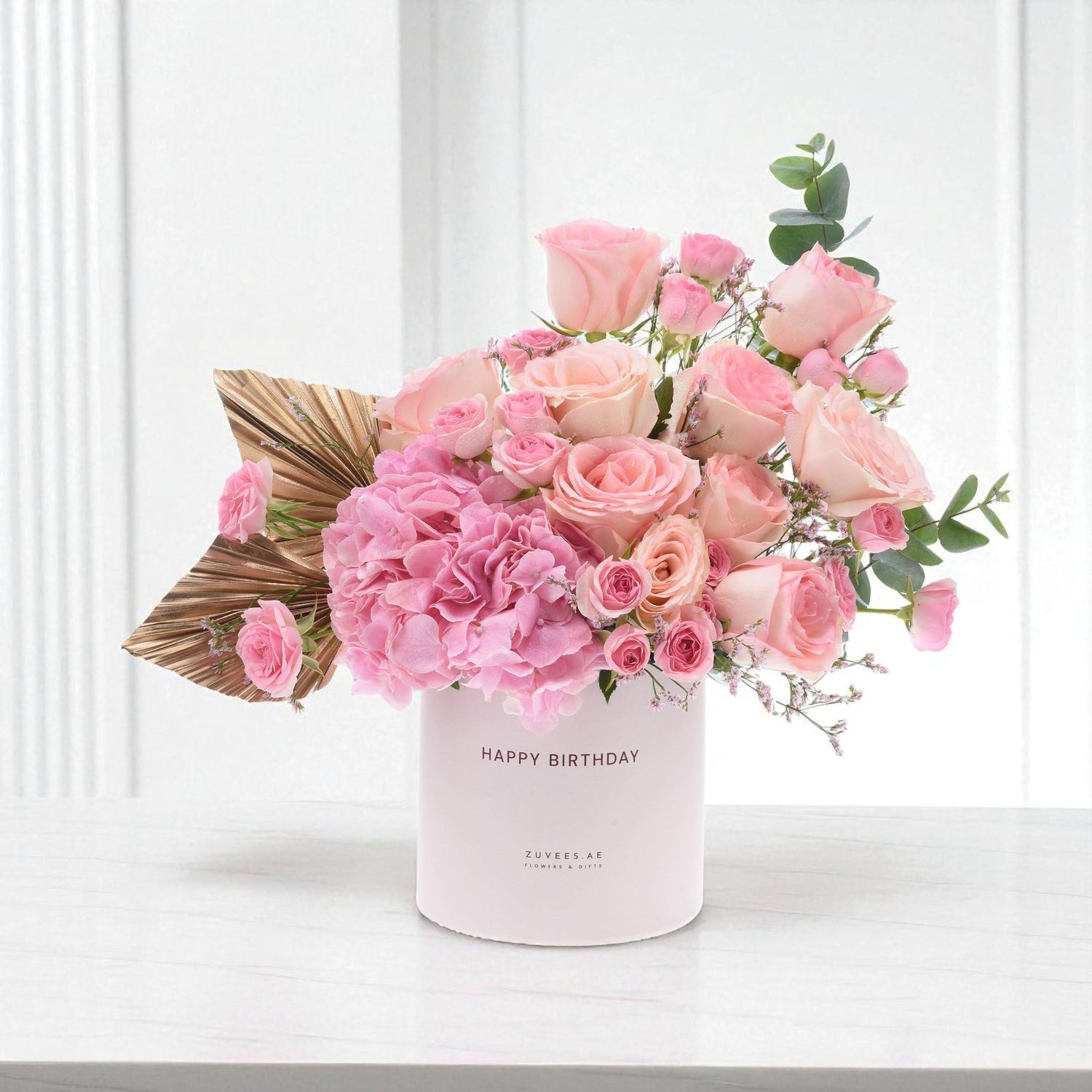 Soft pink roses and hydrangeas in a "Happy Birthday" box with gold leaf accent.