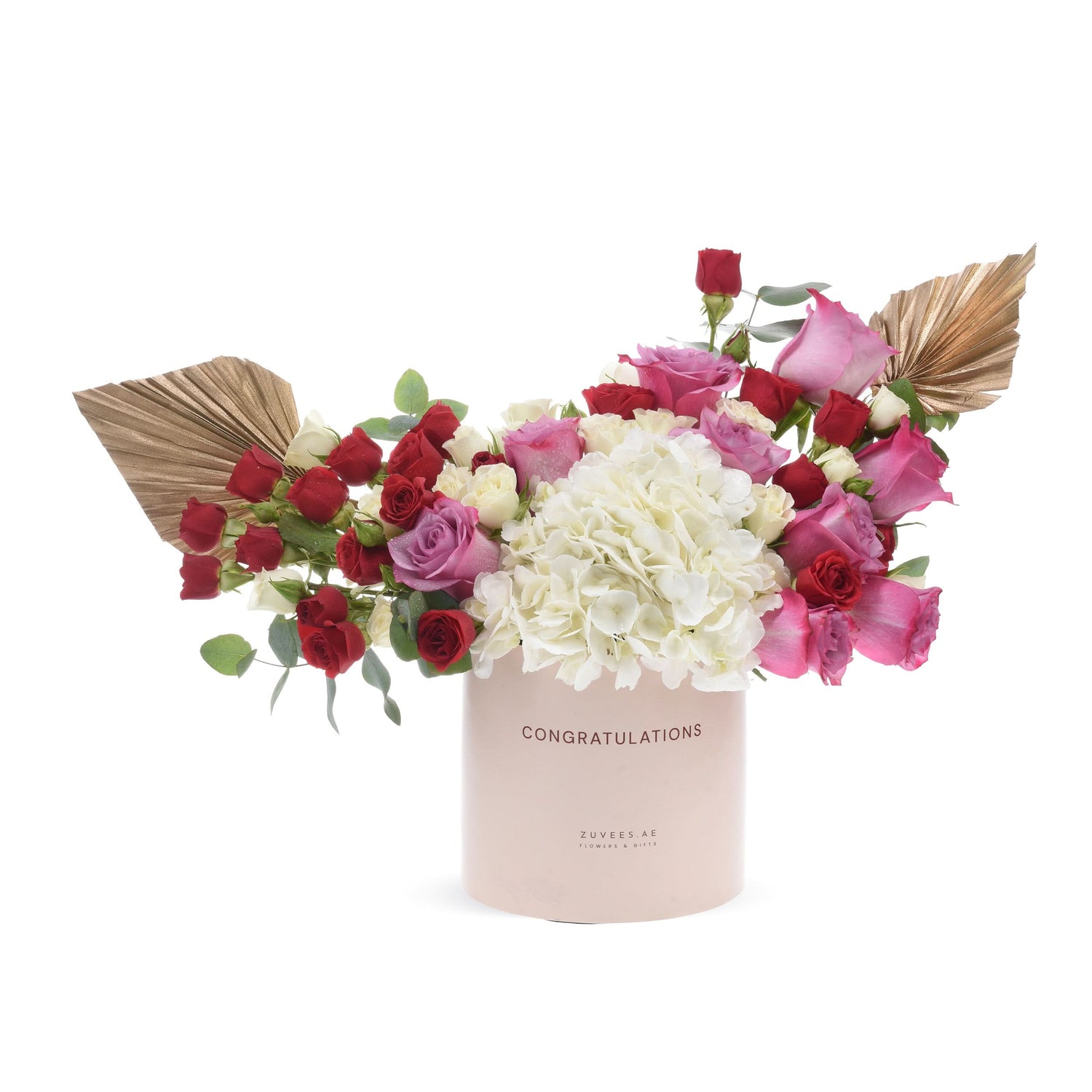 Pink box holds vibrant red, pink, and white roses with gold fan accents.
