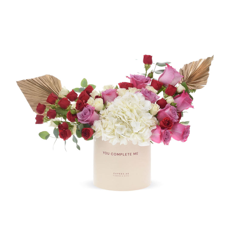 Elegant floral arrangement in cream box with "You Complete Me" text.