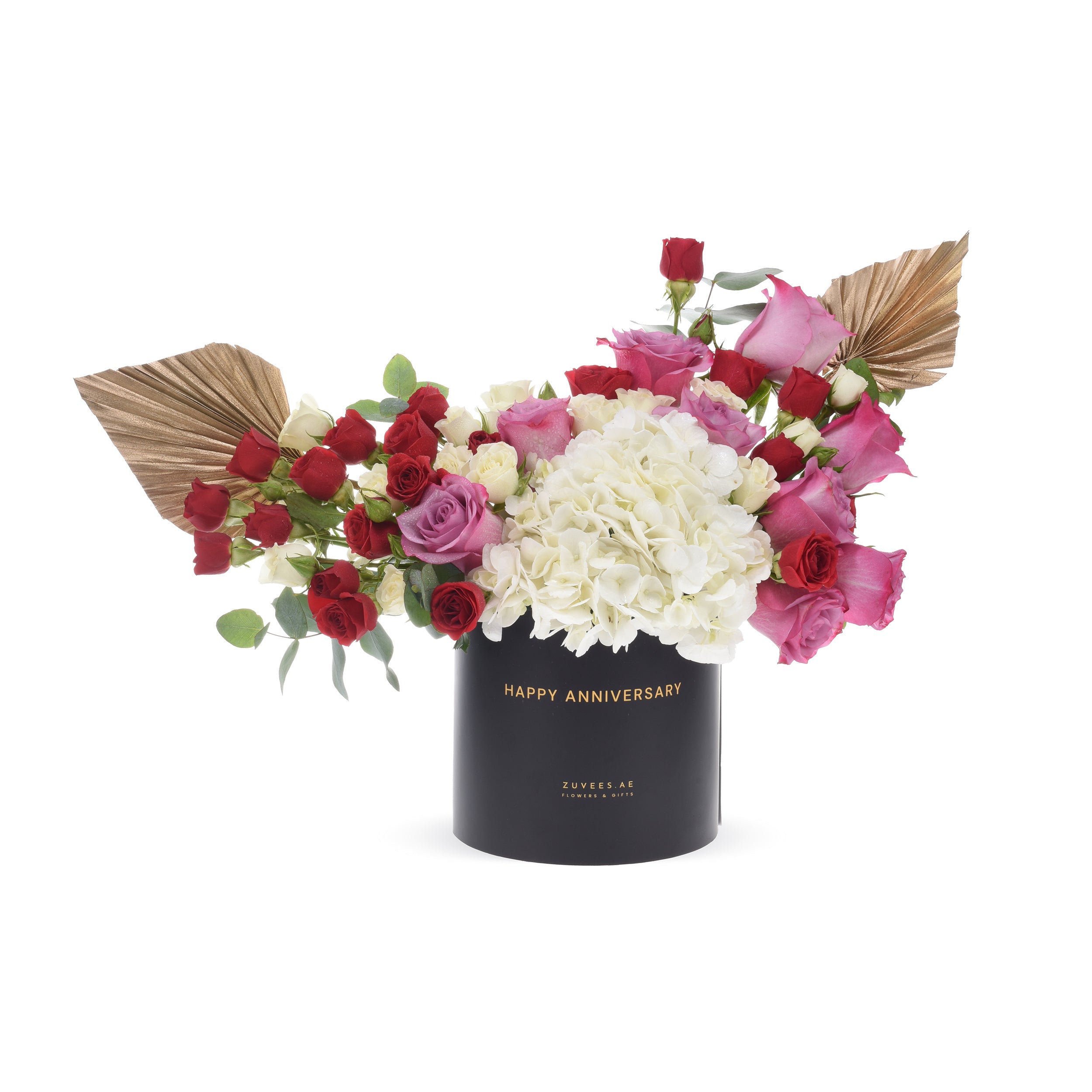 Elegant anniversary bouquet in black box with gold text, red, pink, and white roses, white hydrangeas, and gold fan leaves.