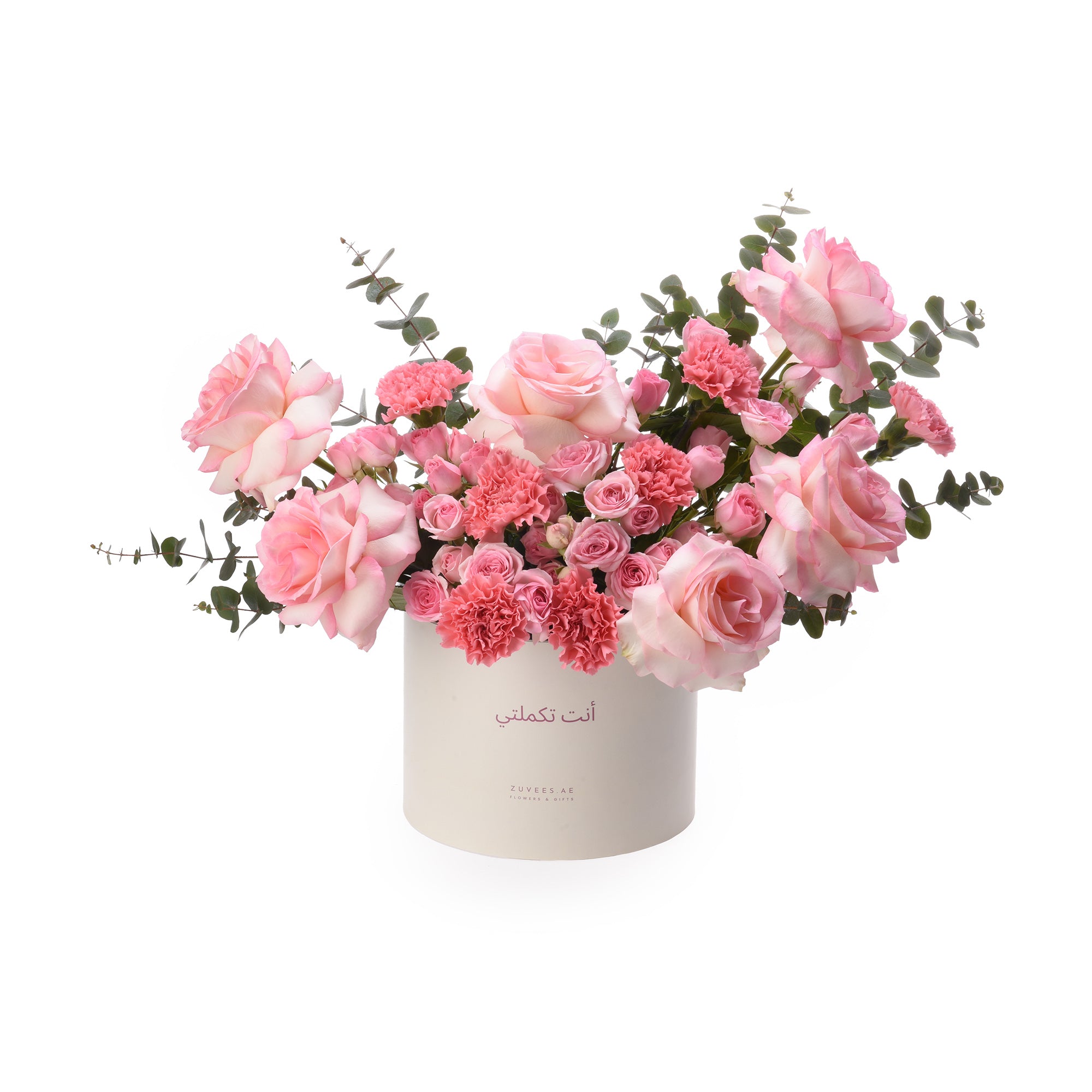 Soft pink roses and carnations in elegant white box with Arabic script.