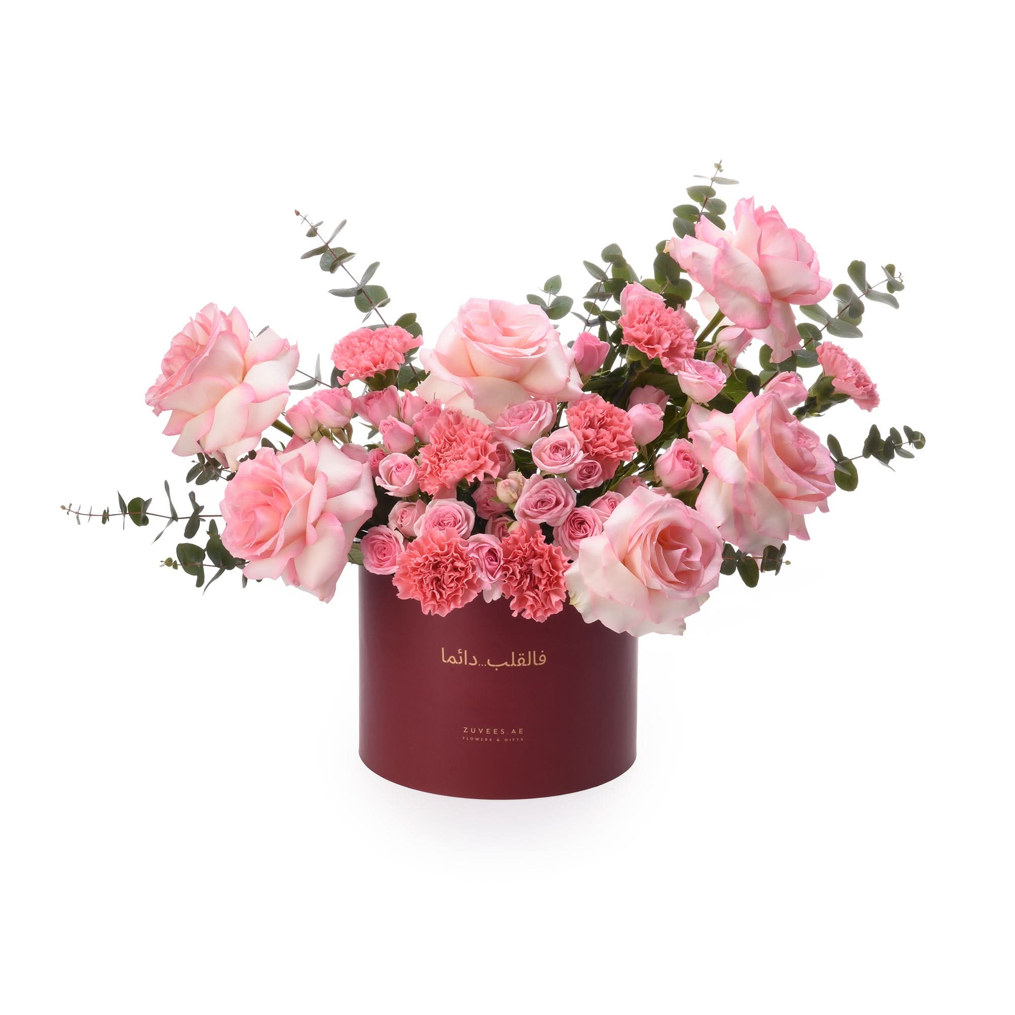 Elegant pink rose and carnation bouquet in deep red cylindrical gift box.
