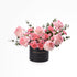 Elegant pink roses and carnations in black "Happy Anniversary" box.
