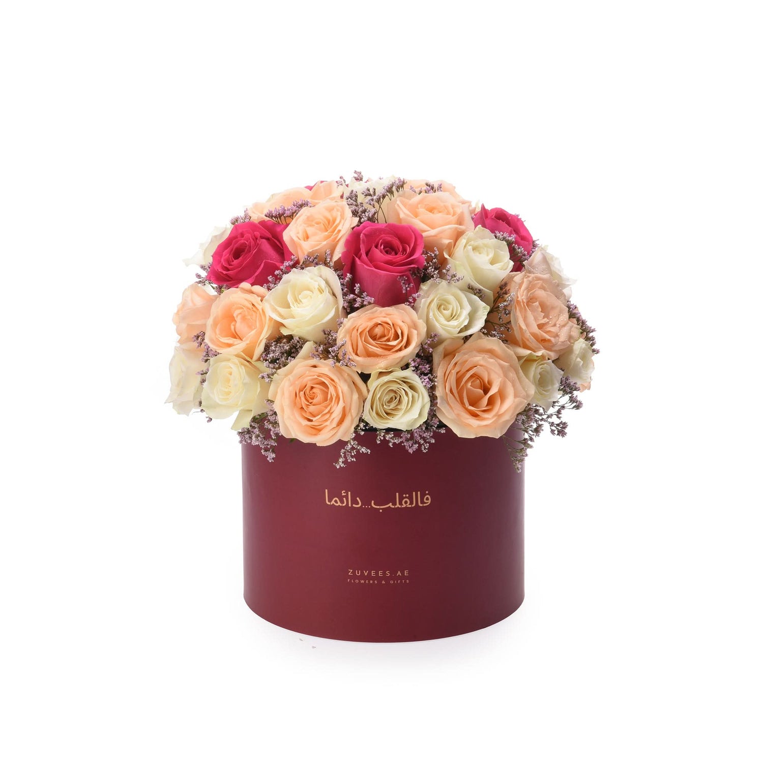 Vibrant multi-toned roses in burgundy box with Arabic text.
