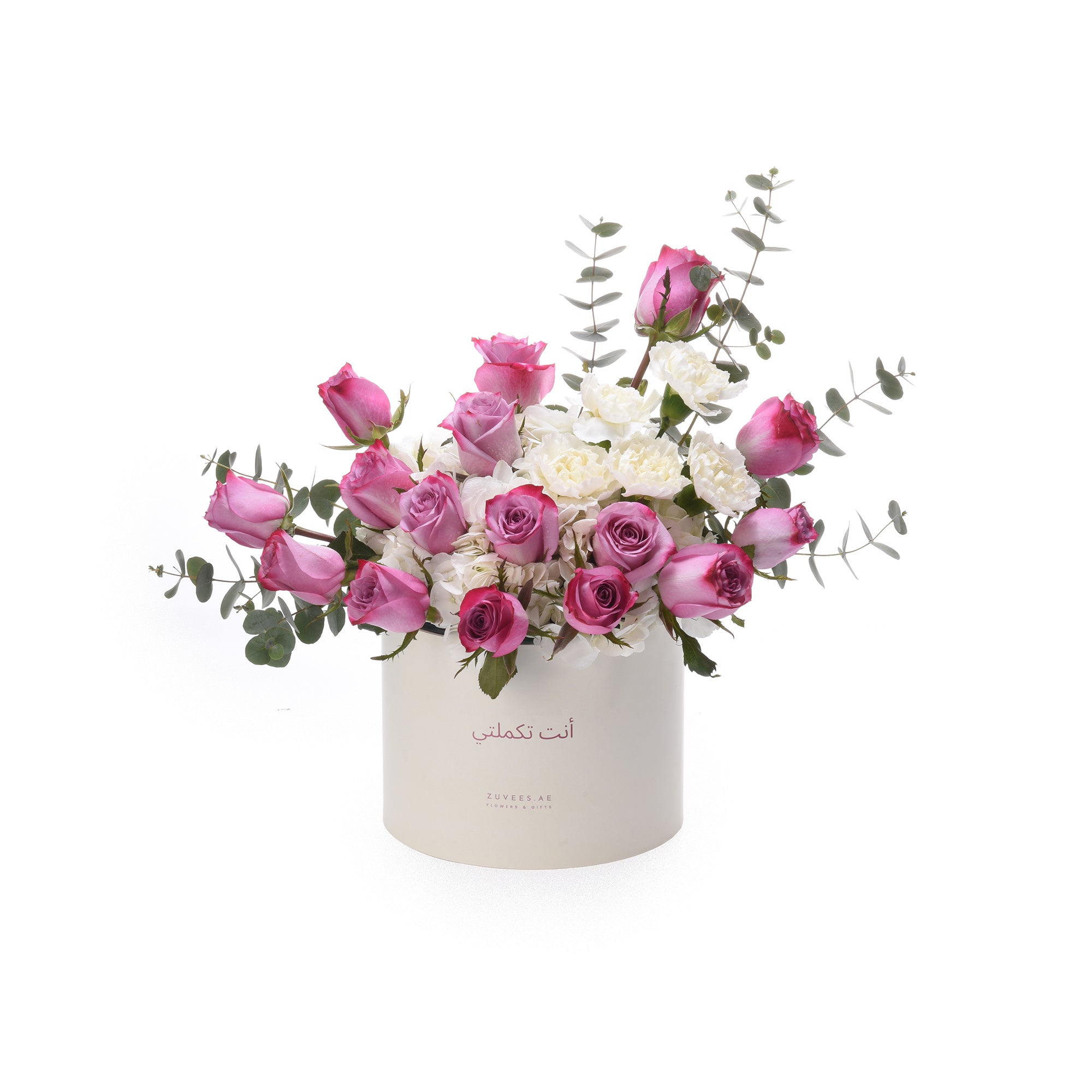 Pink roses, white carnations, eucalyptus in elegant white Zuvees box with Arabic script.