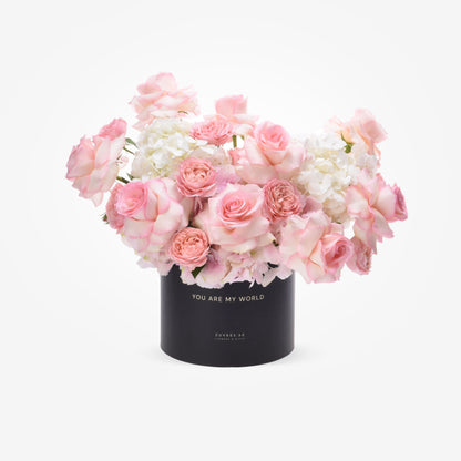 Pink roses and hydrangeas in black box reading "You Are My World".