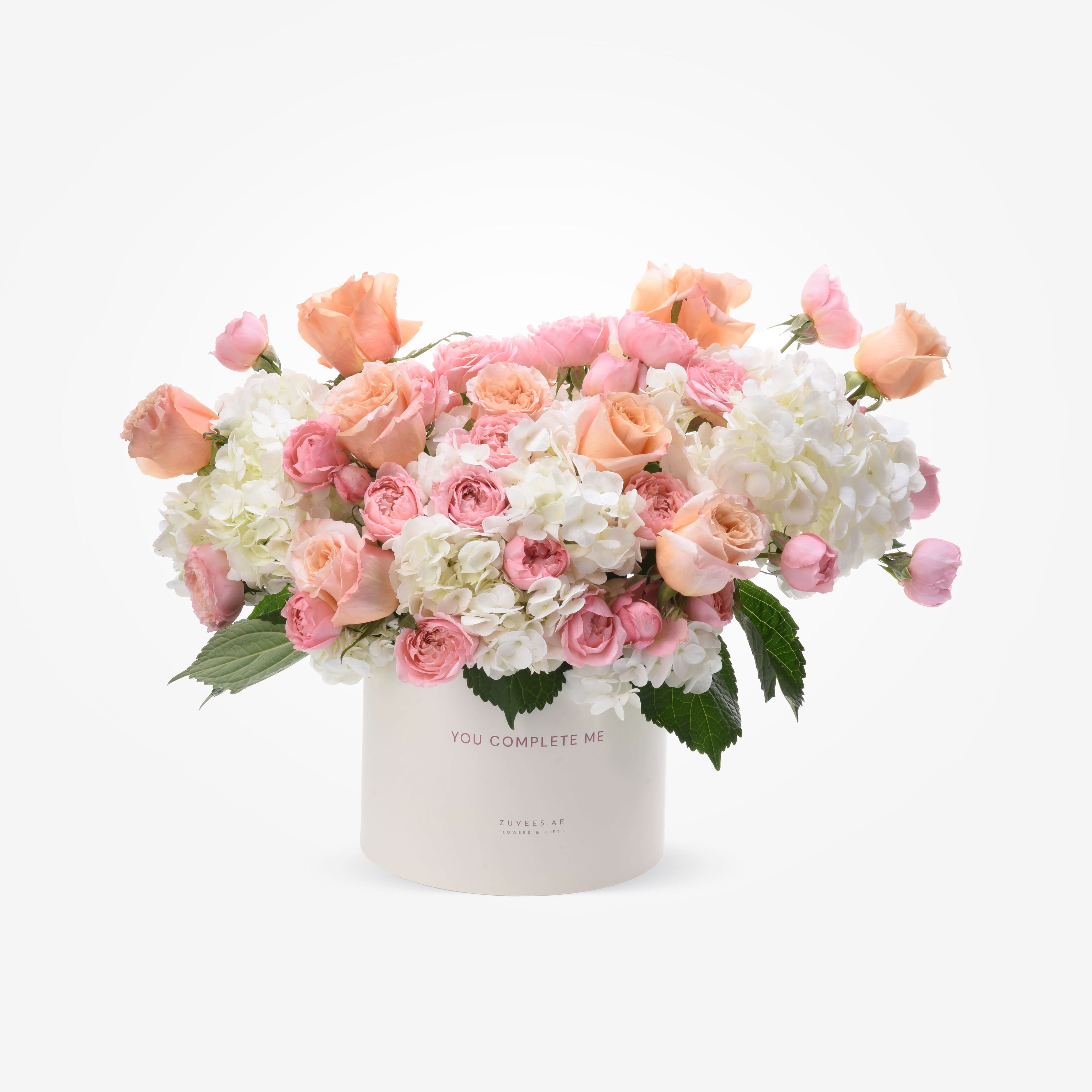 Soft pink roses and white hydrangeas in elegant ivory box with "You Complete Me" message.