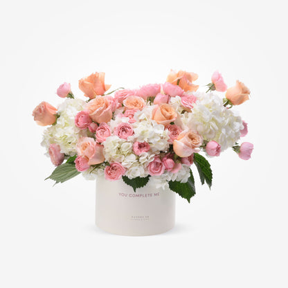 Soft pink roses and white hydrangeas in elegant ivory box with "You Complete Me" message.