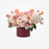 Soft pink roses and white hydrangeas in burgundy box with gold text.