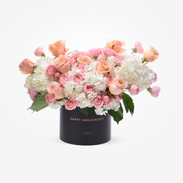 Elegant peach and white rose bouquet in black "Happy Anniversary" box.