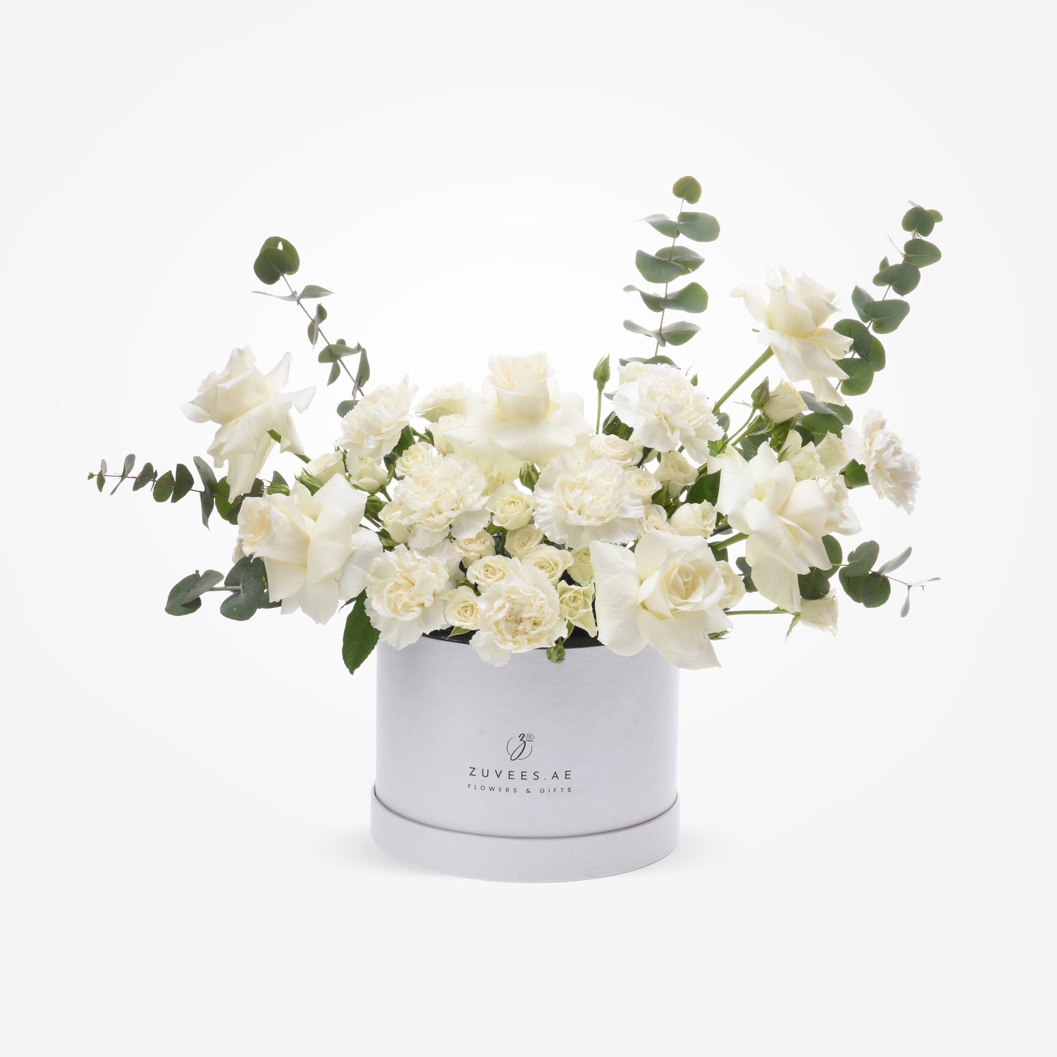 Elegant white roses and carnations with eucalyptus in a minimalist Zuvees.AE gift box.