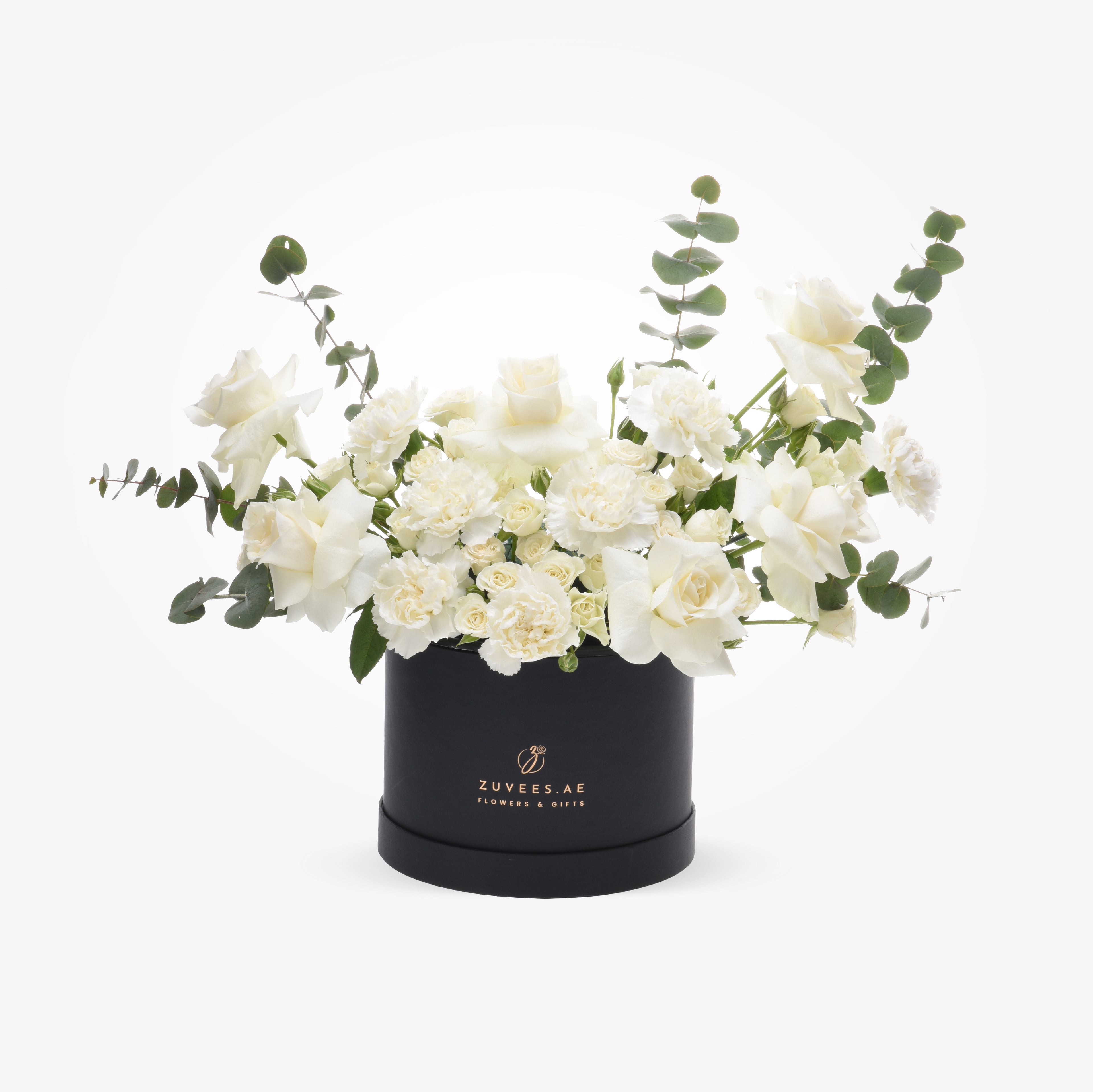 Elegant white roses and carnations with eucalyptus in a black Zuvees.AE gift box.